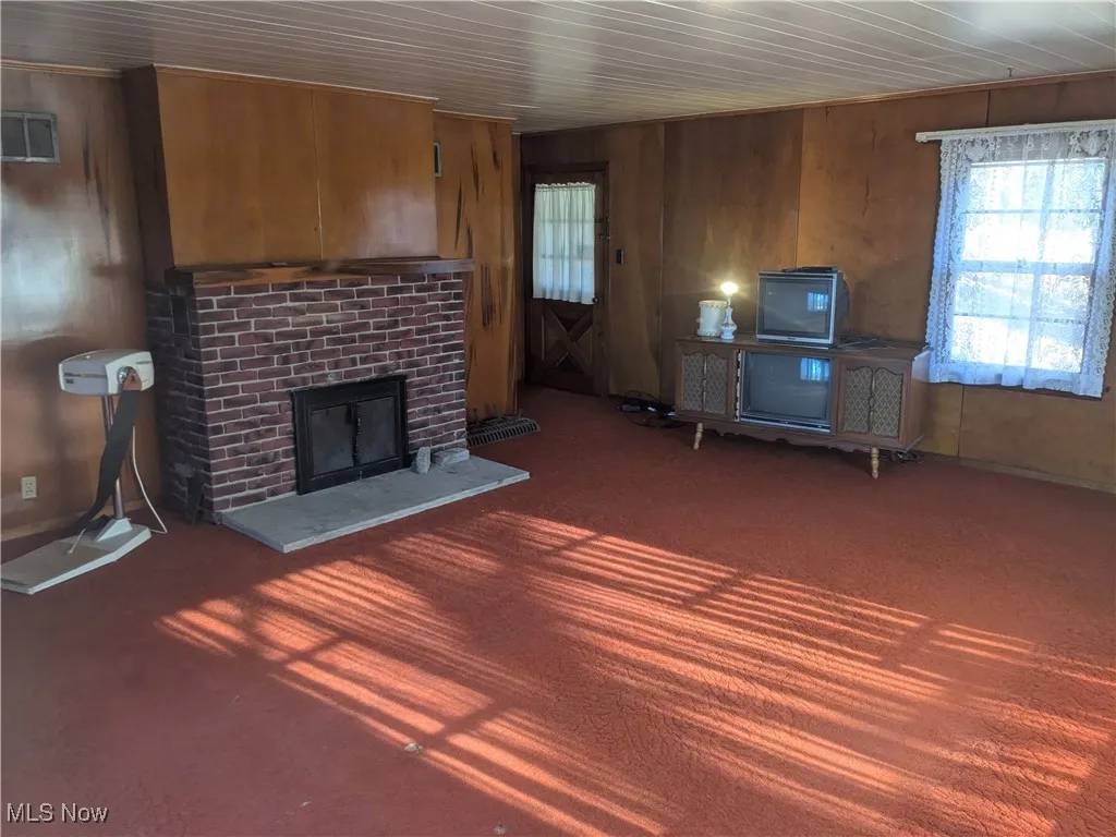 A large living room featuring a brick fireplace