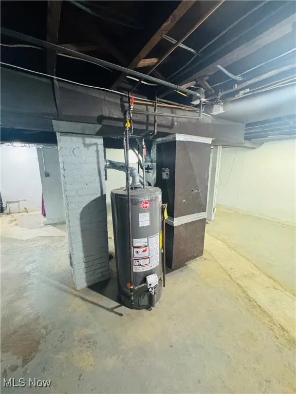 Utility room with gas water heater and heating unit