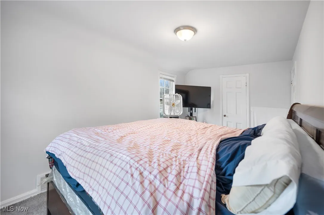 Bedroom featuring baseboards and carpet floors