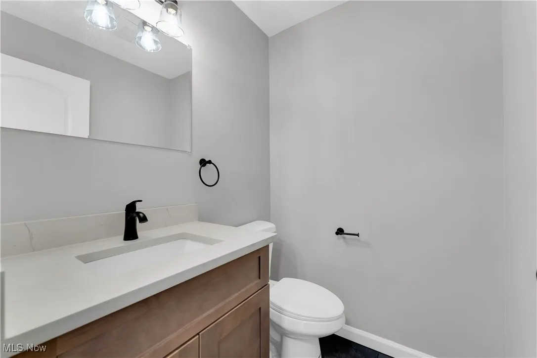 Half bath with vanity and toilet