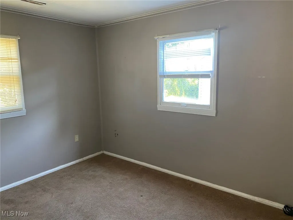 Bedroom #1 with carpet flooring and ornamental molding