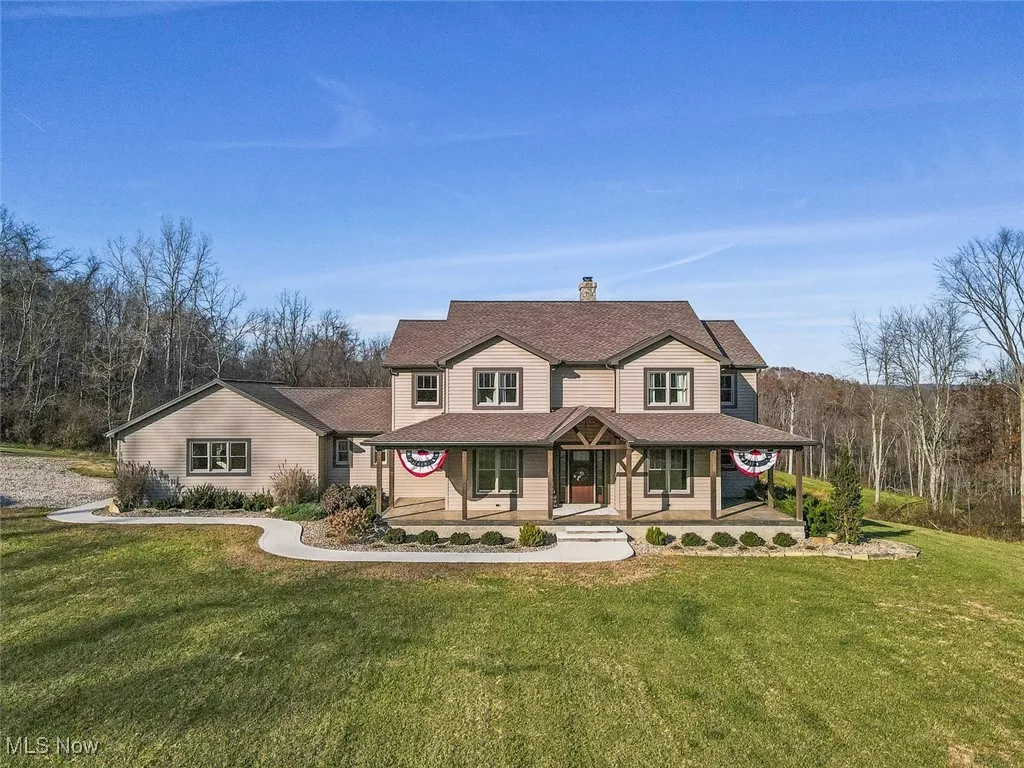 Victorian-style house with a porch, a front lawn, a chimney, and roof with shingles