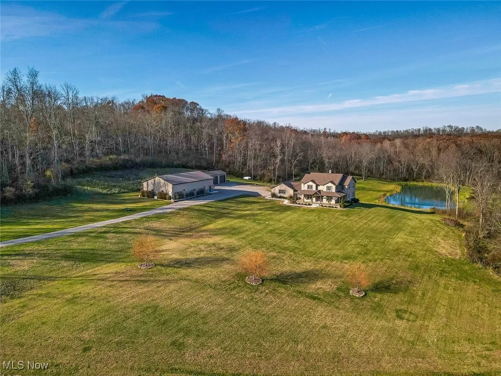 View of subject property featuring a forest and a large body of water