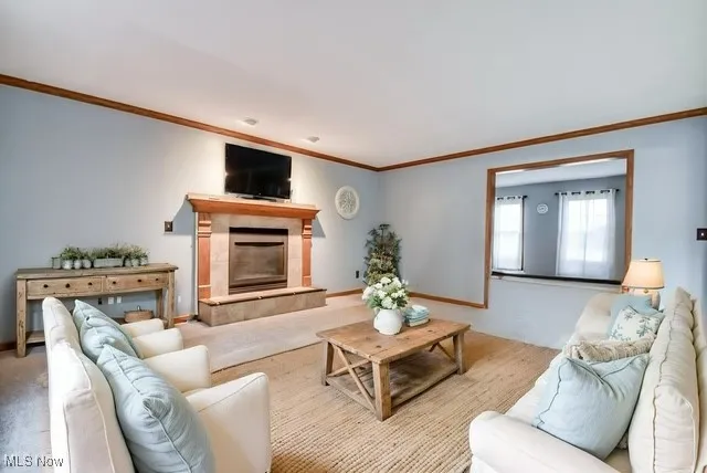 Virtually Staged Family area with new carpet, crown molding, and a fireplace