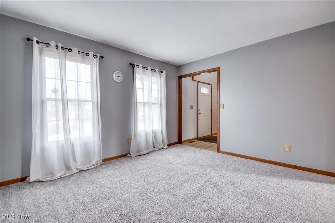 Living room with carpet and baseboards