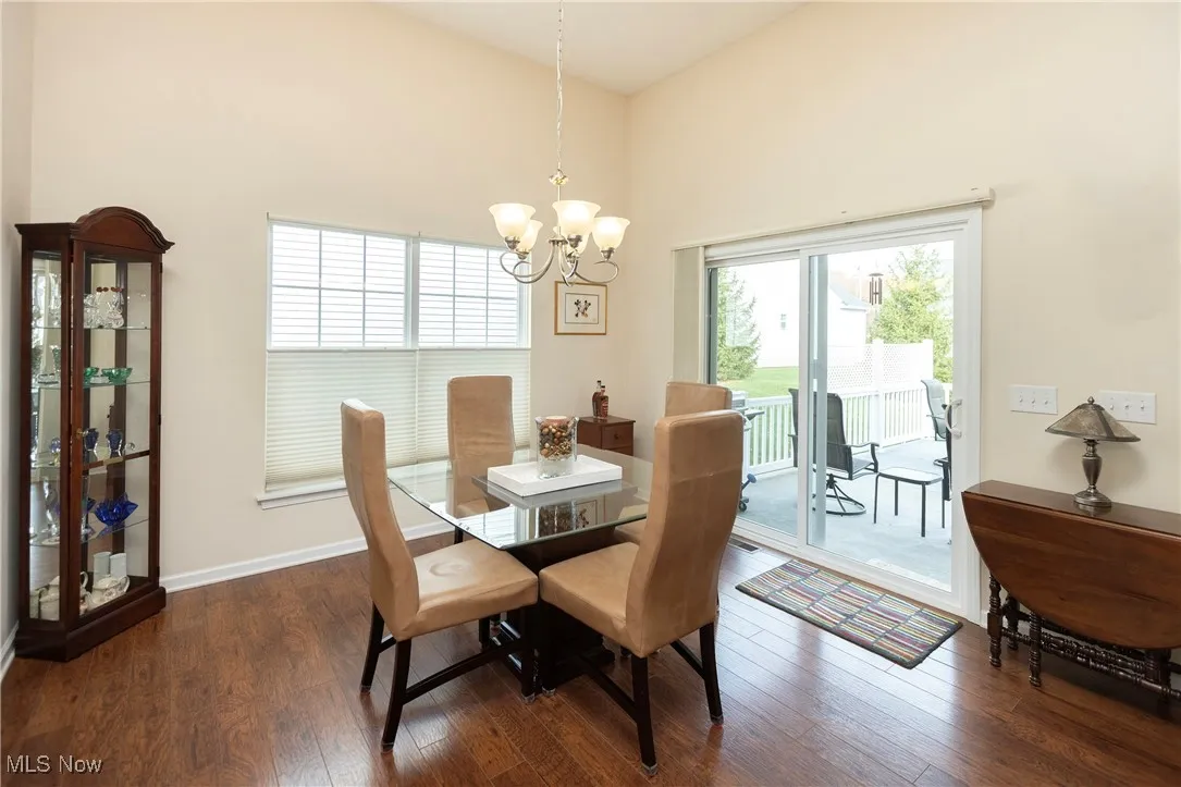 Dining area featuring dark wood finished floors and a chandelier