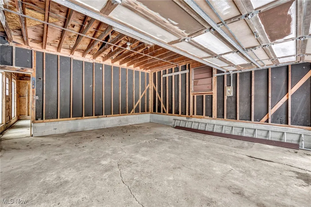 Misc room with a garage and concrete flooring