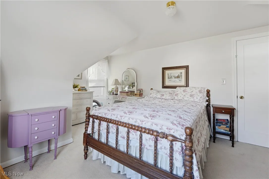 Bedroom featuring light colored carpet