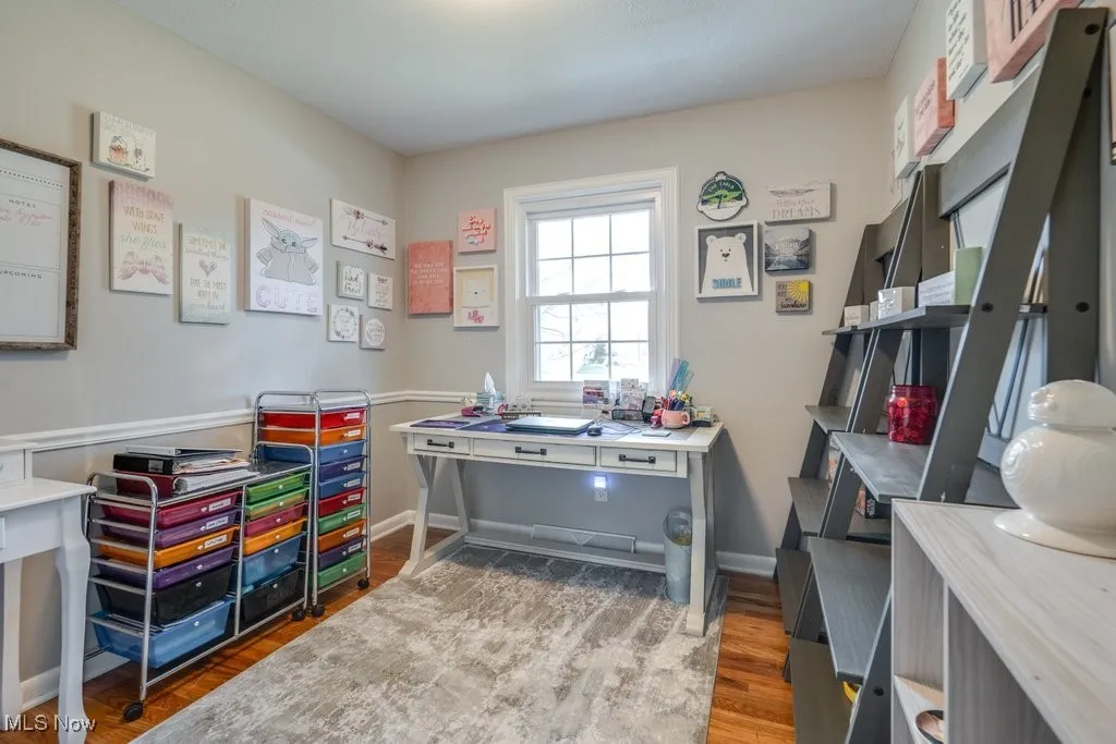 Bedroom with light wood-style floors and baseboards
