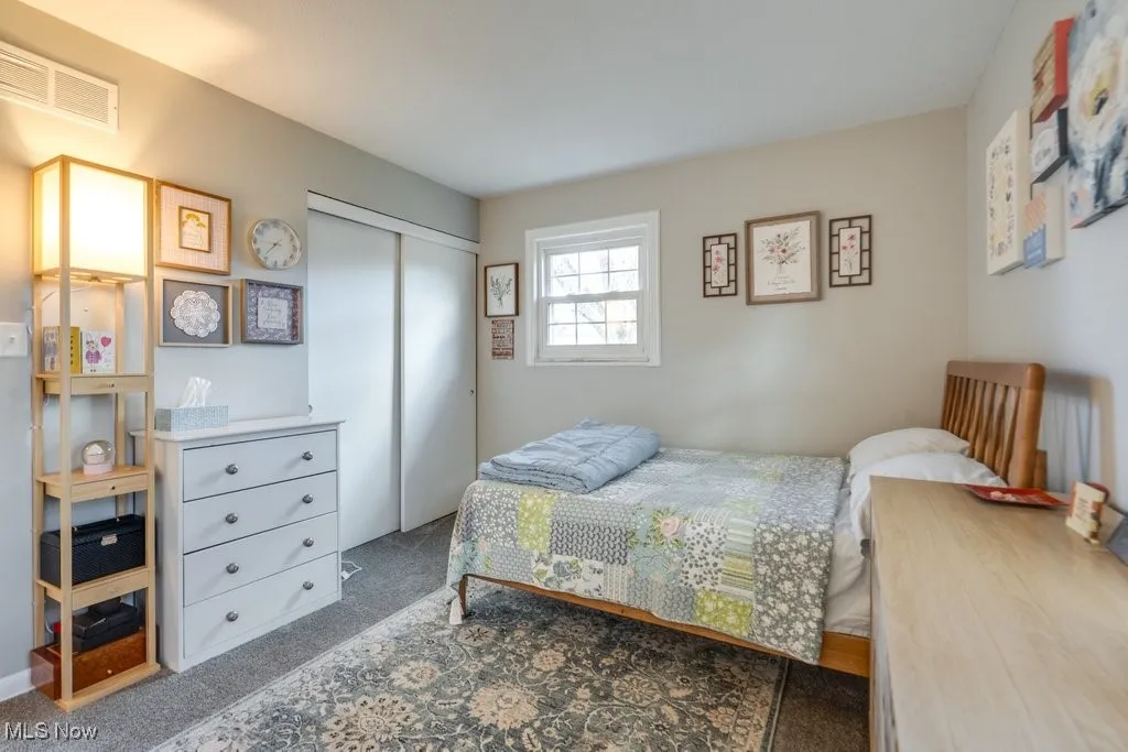 Bedroom featuring carpet floors and a closet