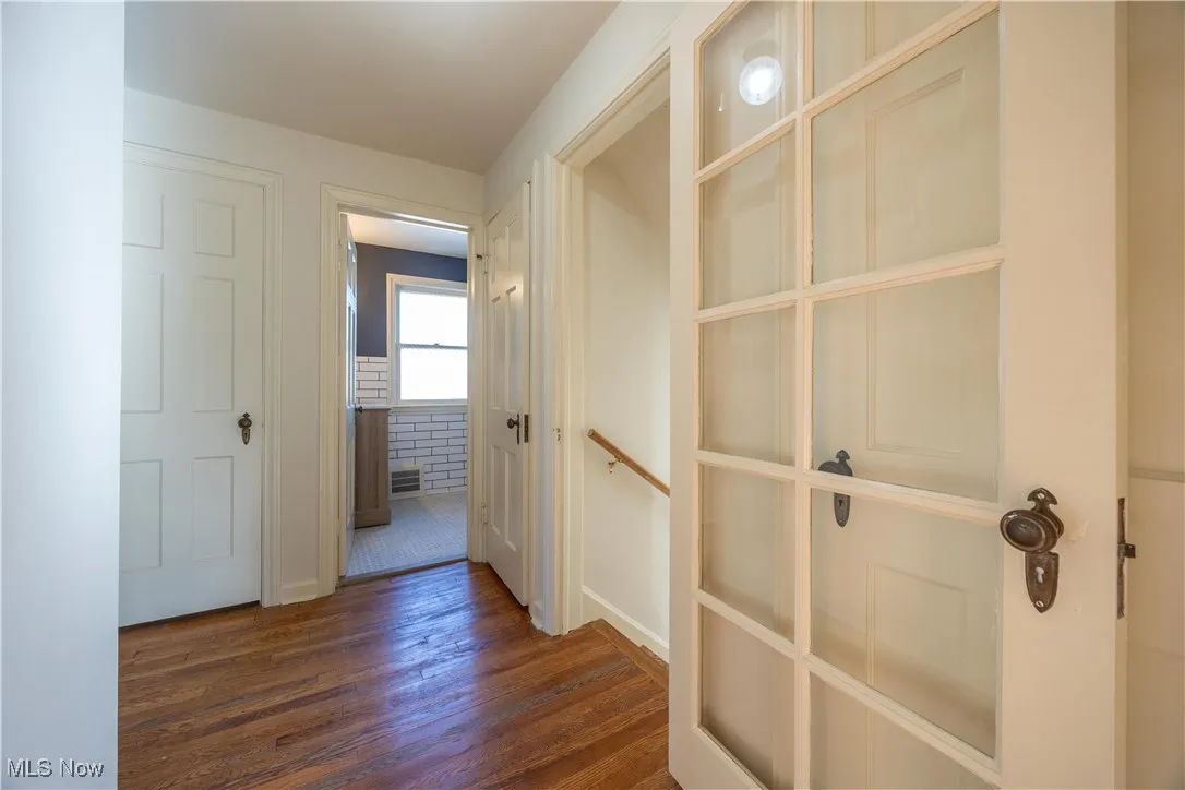 Corridor with dark wood finished floors and baseboards