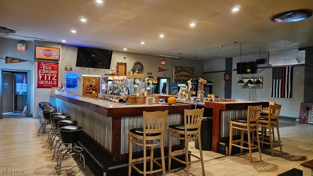 Indoor dry bar featuring butcher block countertops and recessed lighting