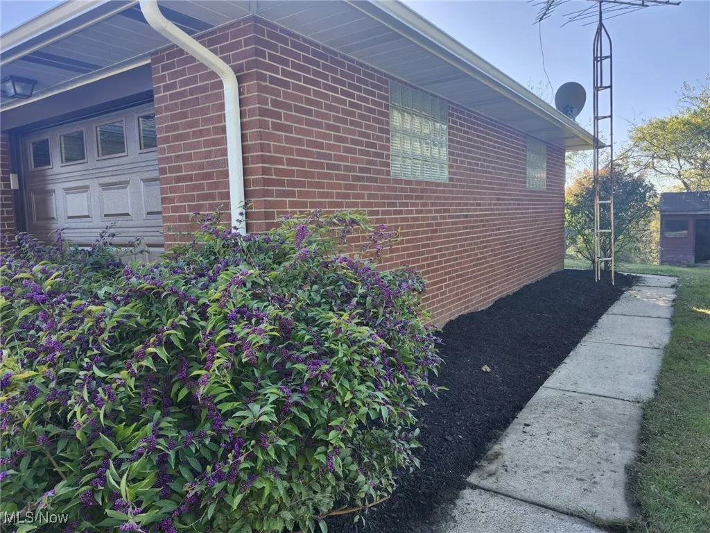 View of side of home featuring brick siding