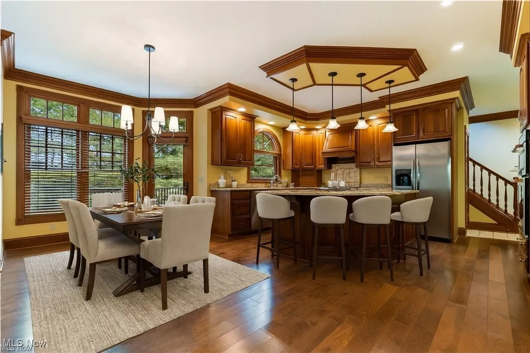  The kitchen shines with warm wood details, a large entertaining island, and an open dining area that creates the perfect hub for everyday living. Virtually Staged.