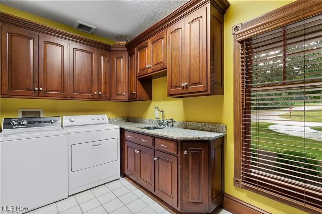 Spacious first-floor laundry room featuring ample workspace and convenient built-in cubbies for organized storage