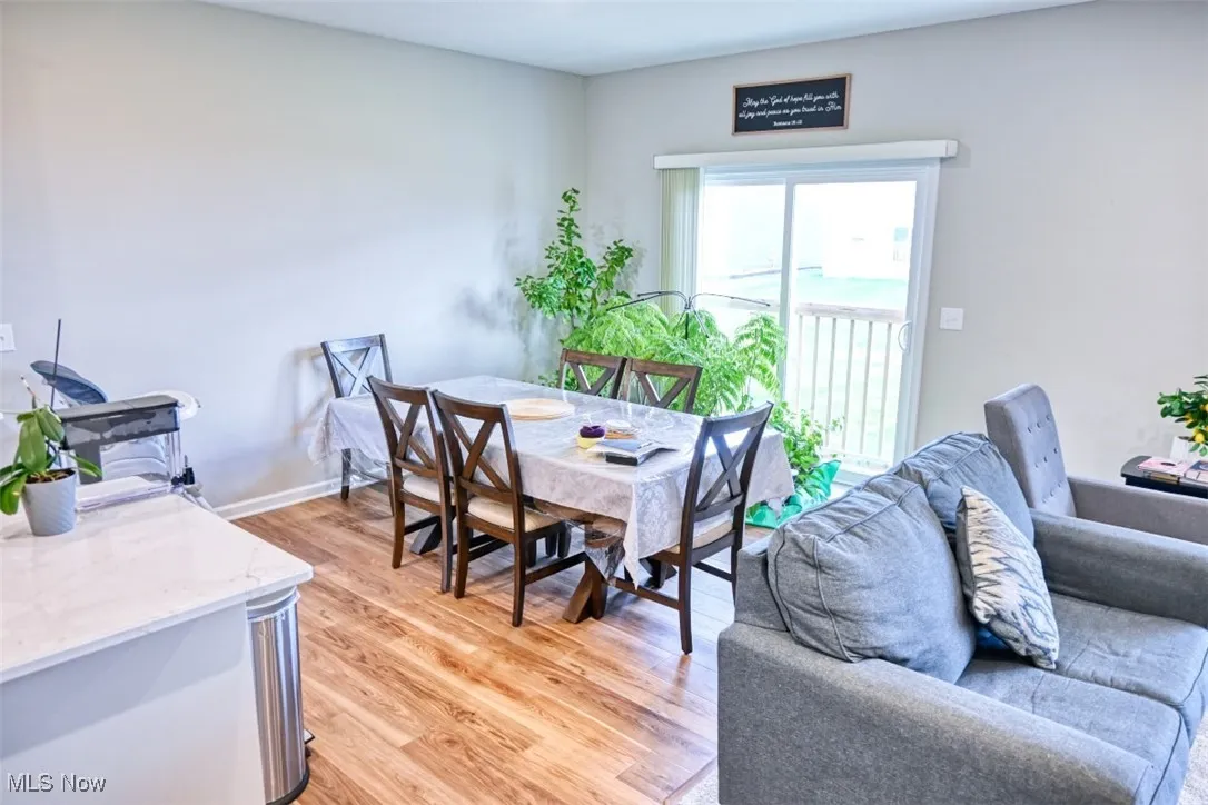 Dining room featuring light wood-style flooring and baseboards