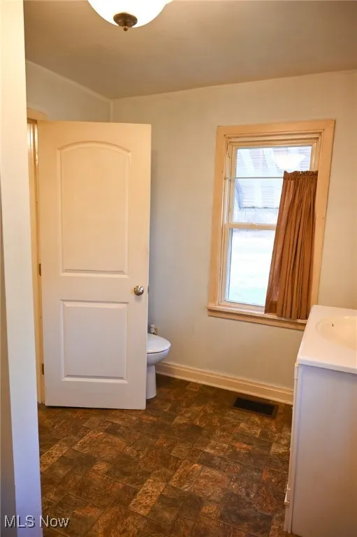 Bathroom with vanity and baseboards