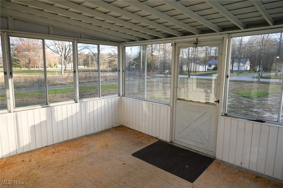 Unfurnished sunroom with a residential view