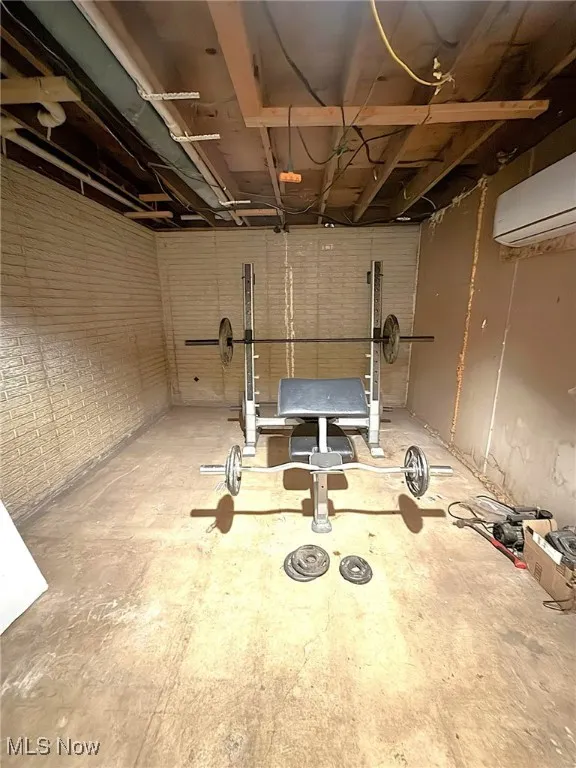 Basement featuring an AC wall unit, can be a 5th bedroom to finish off