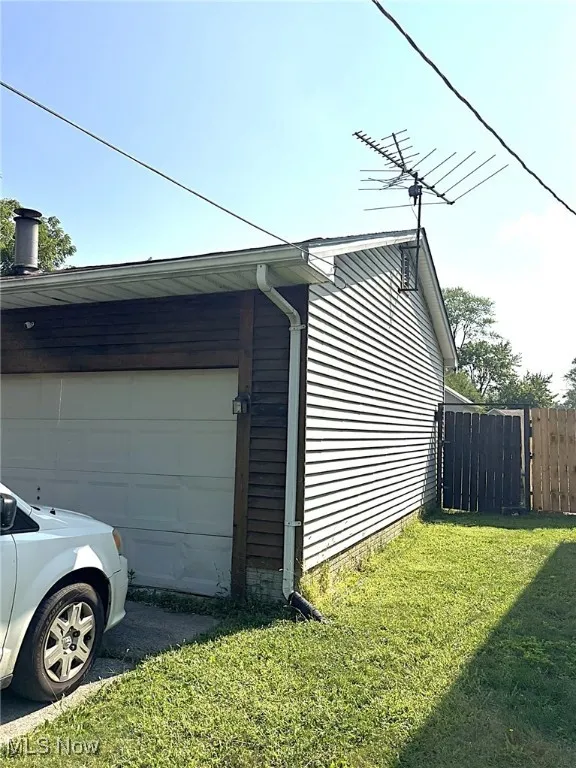 View of property exterior with a garage