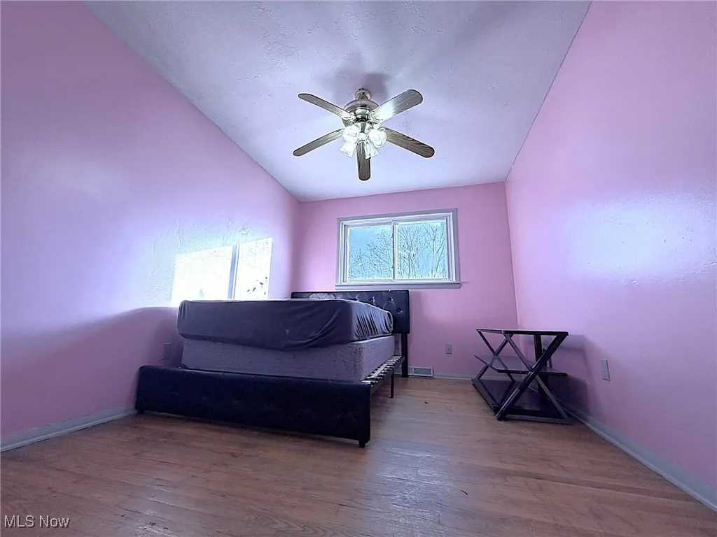 Bedroom featuring wood-type flooring and a ceiling fan