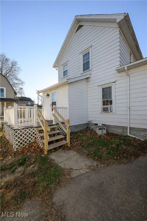 Back of house featuring a wooden deck