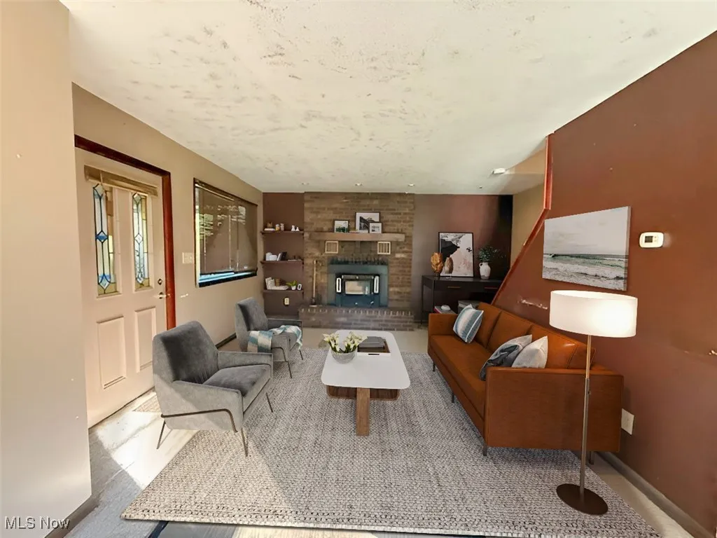 Living area with a fireplace and baseboards