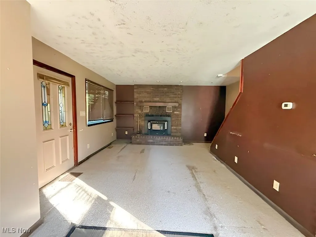 Unfurnished living room with a fireplace