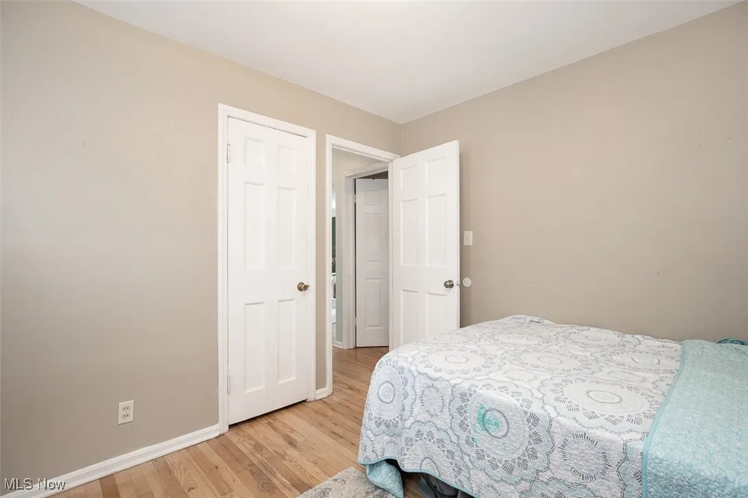 Bedroom with light wood-style floors and baseboards