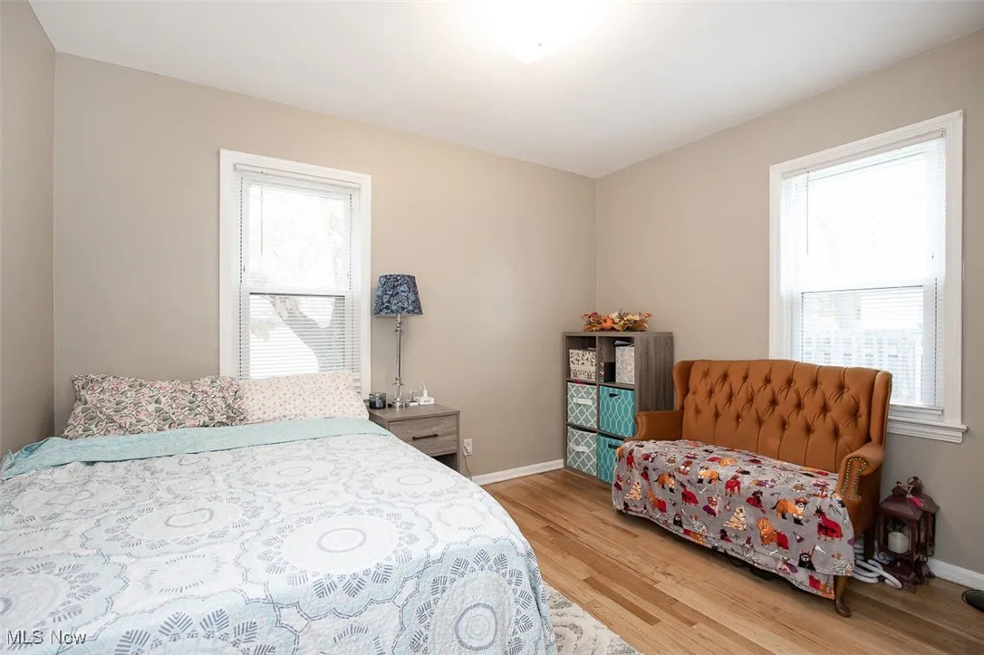 Bedroom featuring light wood-style flooring and multiple windows