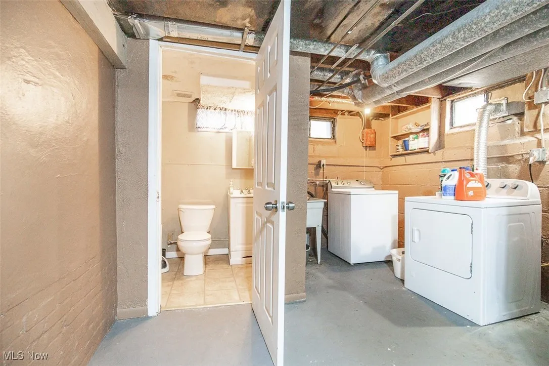 Laundry room featuring concrete flooring and independent washer and dryer