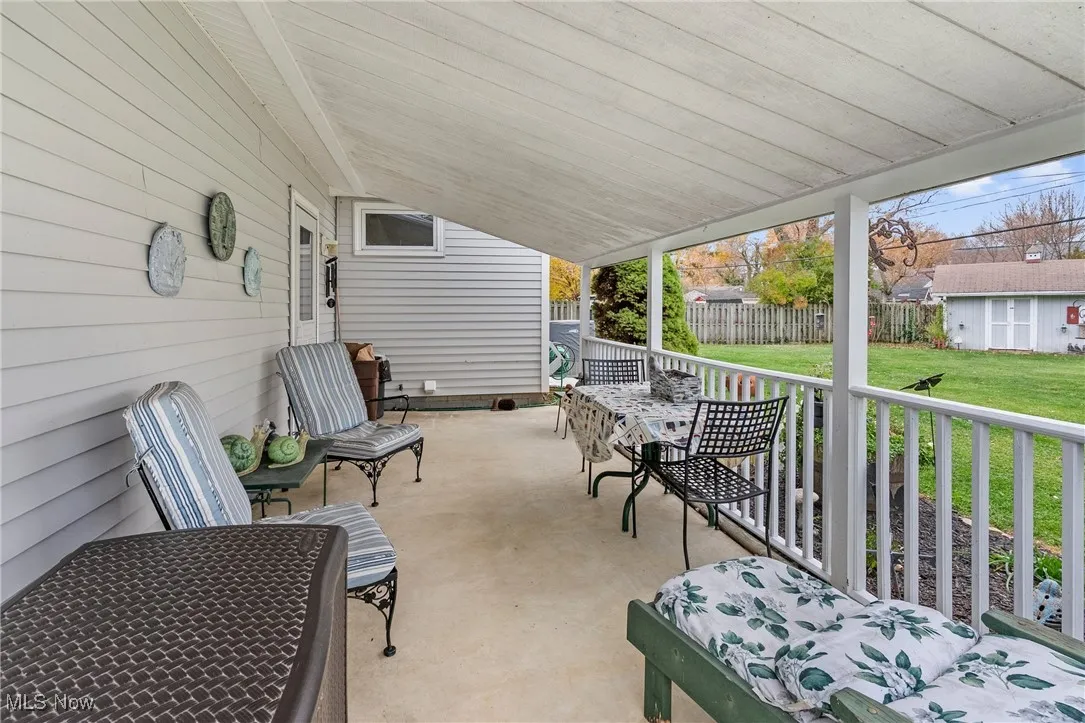 Covered porch featuring an outdoor structure