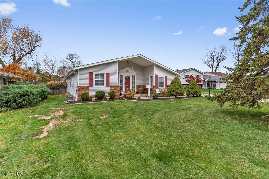 View of front of property with a front lawn and brick siding