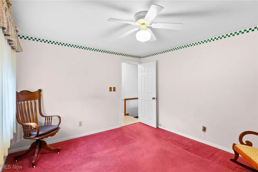 Unfurnished room featuring a ceiling fan and carpet flooring