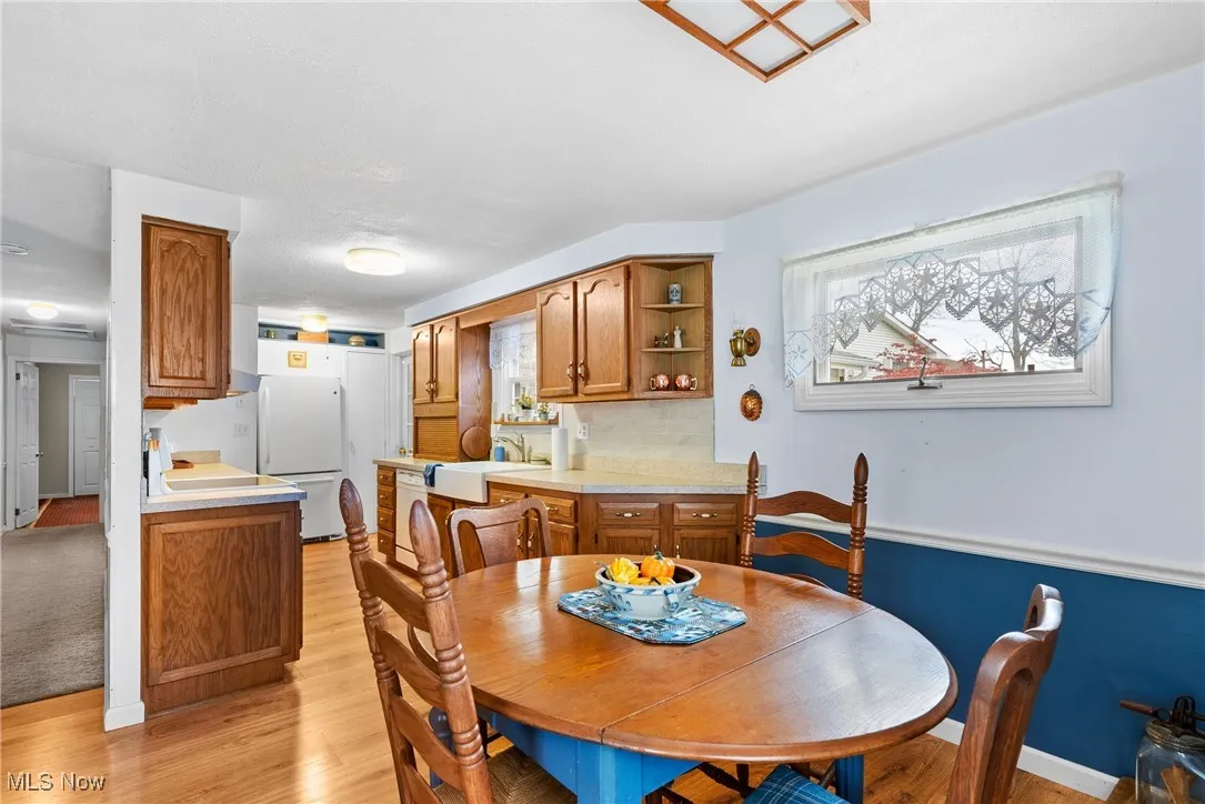 Dining area featuring light wood-type flooring and baseboards
