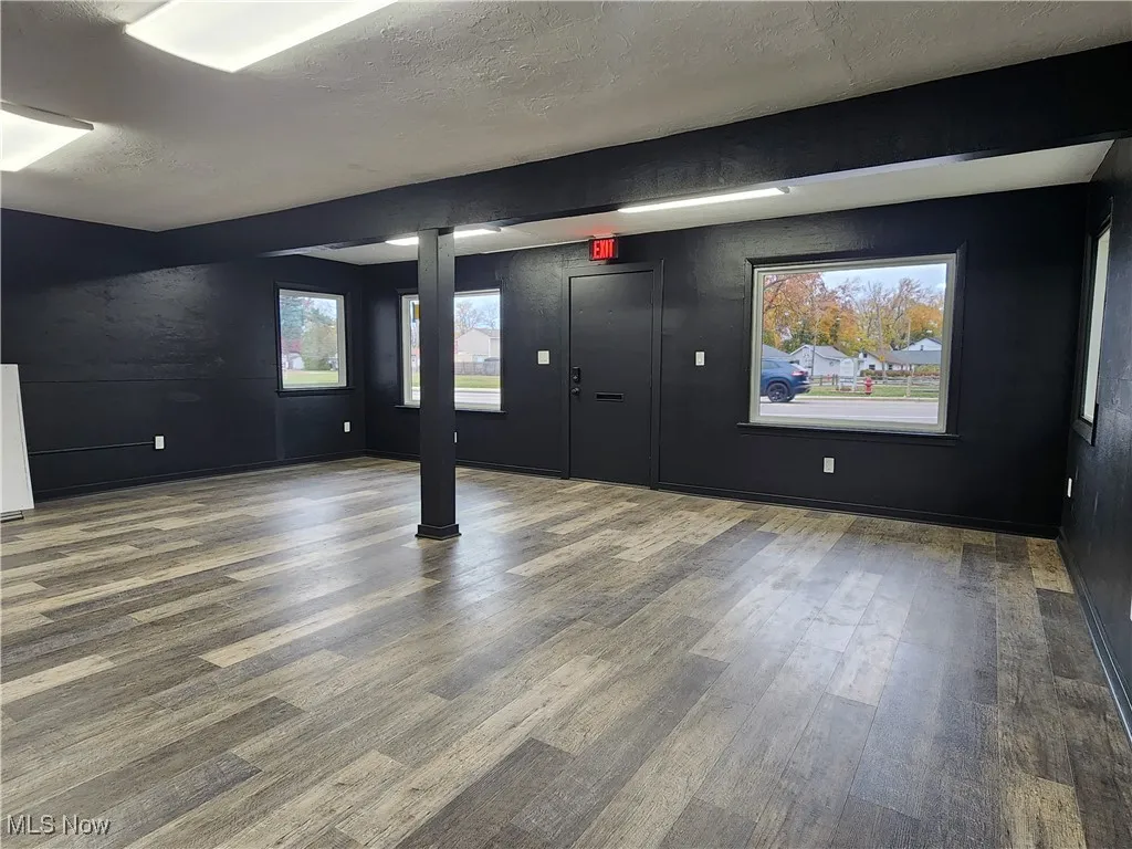 Main area wood finished floors and a textured ceiling