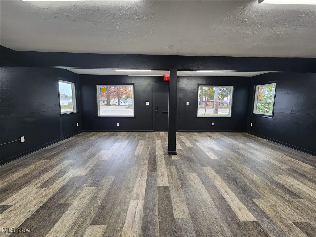 Unfurnished room featuring wood finished floors and a textured ceiling