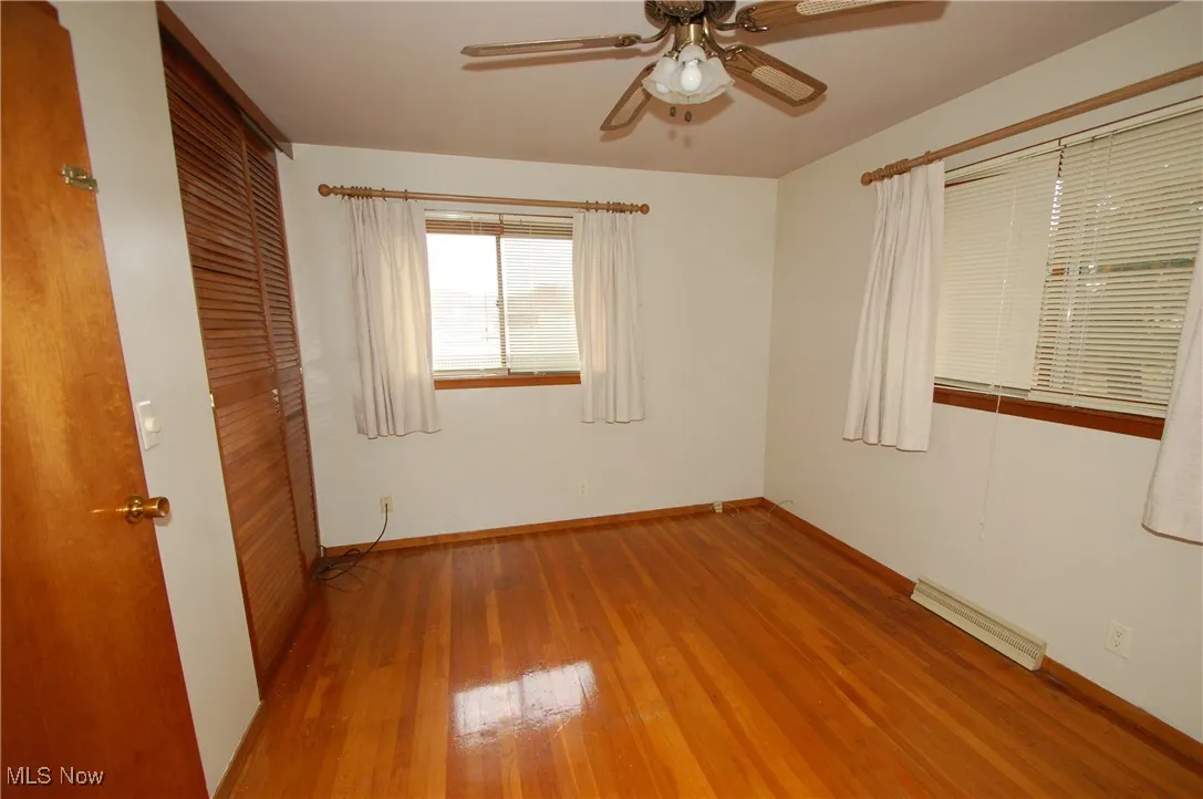 Unfurnished bedroom with a closet, light wood-type flooring, and ceiling fan