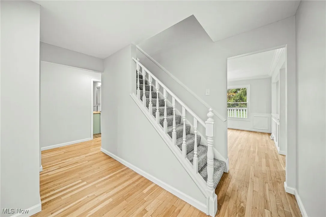 Stairs featuring wood finished floors and baseboards