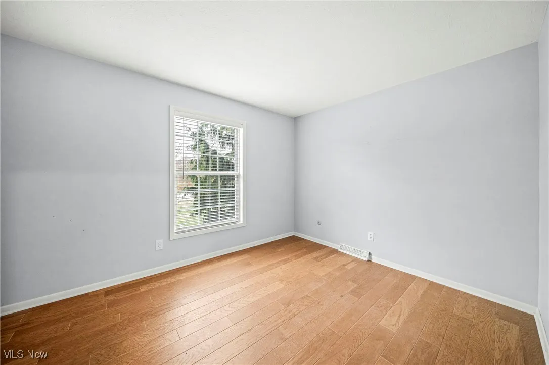 Unfurnished room featuring baseboards and light wood-style flooring