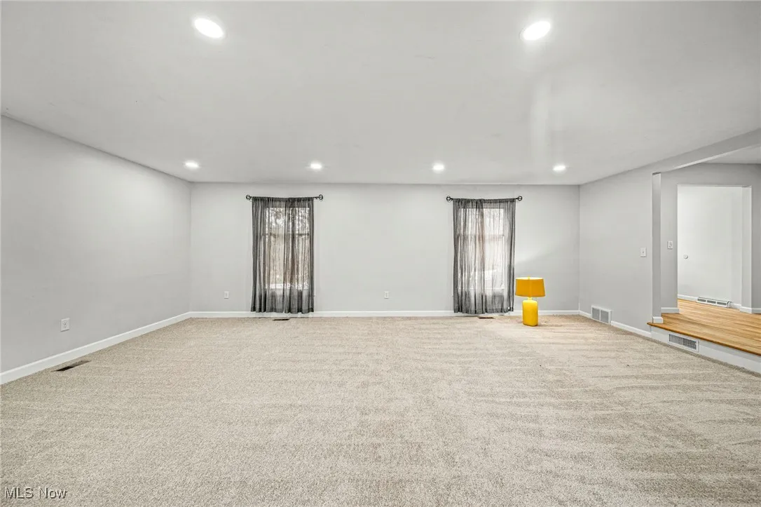 Carpeted spare room with recessed lighting