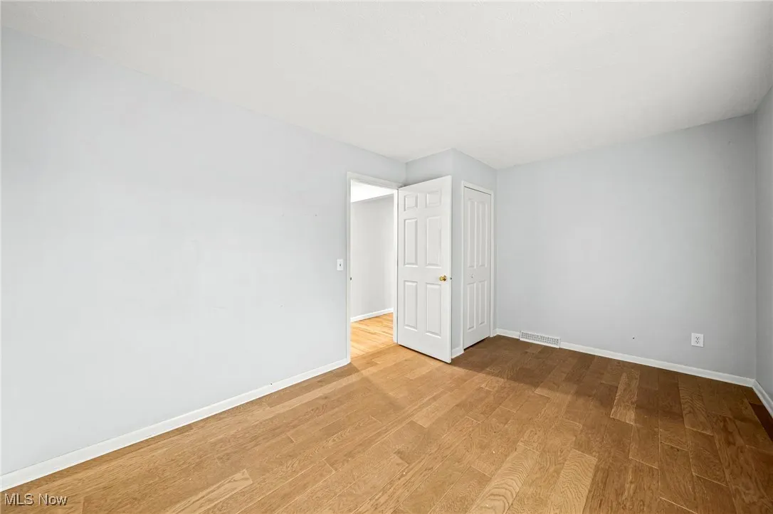 Unfurnished room featuring baseboards and light wood finished floors
