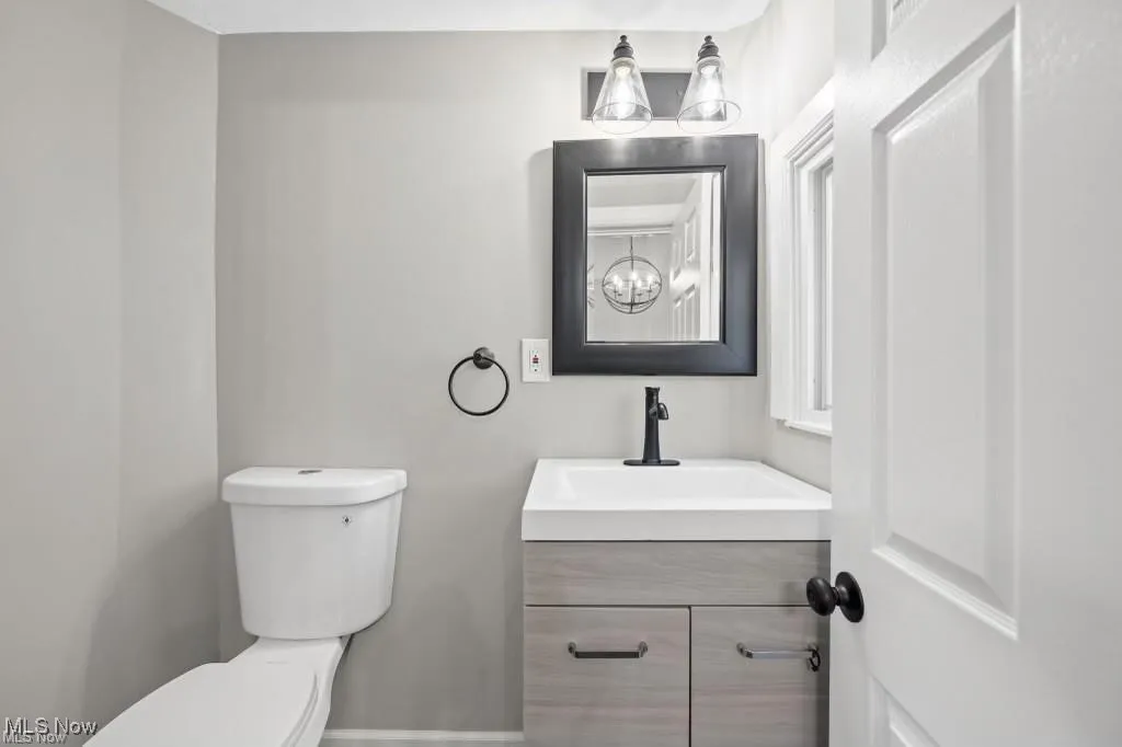 Half bath featuring vanity and toilet