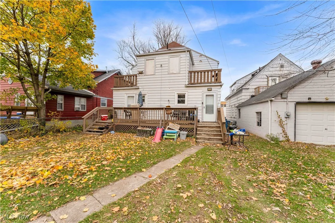 Back of house featuring a balcony and a deck