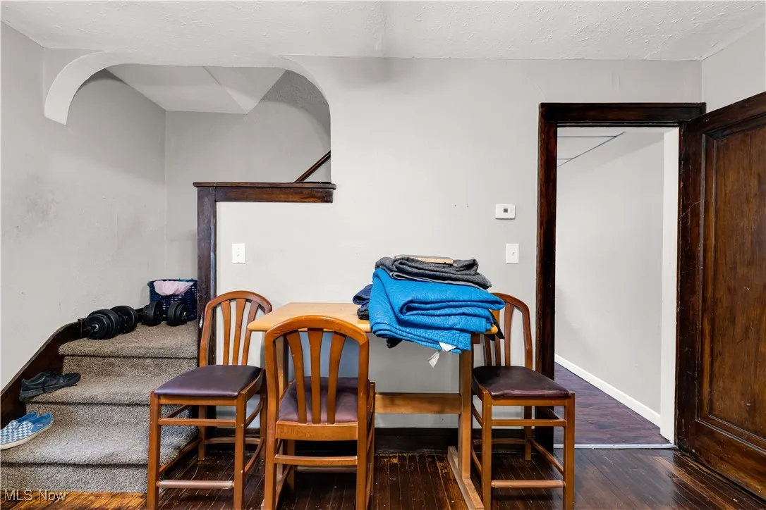 Dining space featuring dark wood-type flooring and a textured ceiling