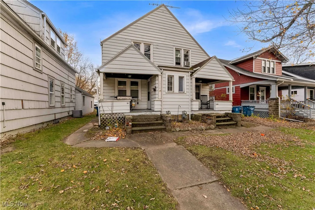 Back of house featuring a lawn and a porch