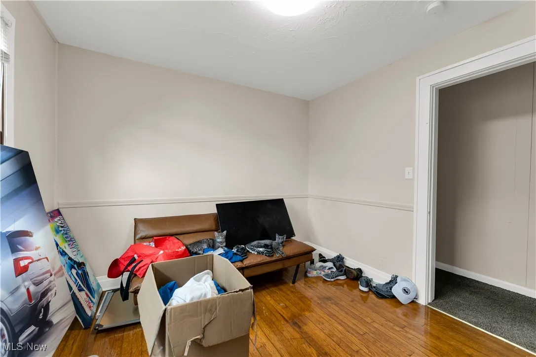 Bedroom featuring hardwood / wood-style flooring and a textured ceiling