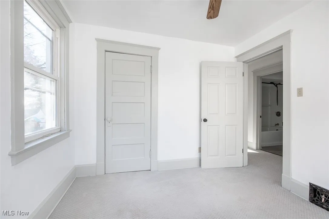 Unfurnished bedroom with carpet and baseboards