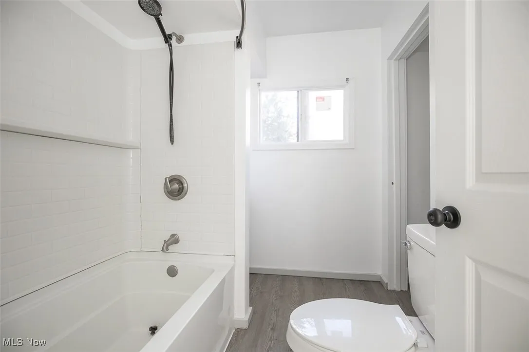 Full bath with bathing tub / shower combination and light wood finished​​‌​​​​‌​​‌‌​‌‌​​​‌‌​‌​‌​‌​​​‌​​ floors