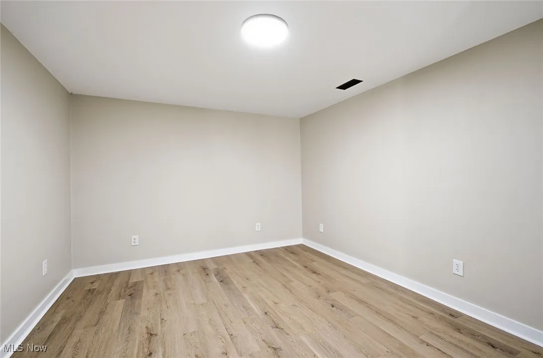 Spare room with light wood-style flooring and baseboards